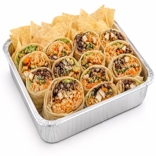 A catering tray of Picante Taco Restaurant's burritos cut in half, with tortilla chips.