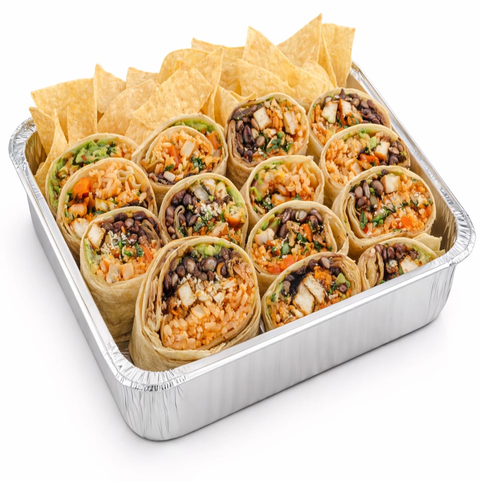 A catering tray of Picante Taco Restaurant's burritos cut in half, with tortilla chips.